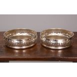 A PAIR OF GEORGE III STYLE SILVER COASTERS, T.C.P.