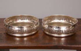 A PAIR OF GEORGE III STYLE SILVER COASTERS, T.C.P.