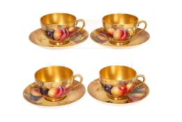 A SET OF FOUR ROYAL WORCESTER FRUIT PAINTED CABINET TEACUPS AND SAUCERS, painted by J.