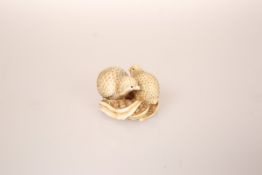 A JAPANESE IVORY QUAIL NETSUKE, the two birds facing in opposite directions and standing on millet,