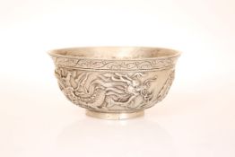 A CHINESE WHITE METAL BOWL, cast with dragons, seal mark. 13.