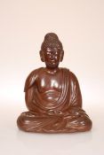 AN UNUSUAL BROWN STONEWARE BUDDHA, modelled meditating.
