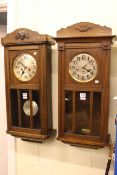 Two similar 1920's/30's oak cased wall clocks