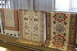Collection of three beige ground rugs
