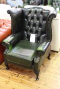 Green leather deep buttoned wing back armchair on cabriole legs