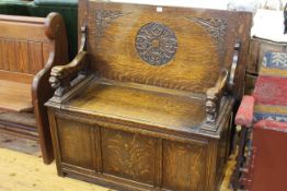 Carved oak monks bench with lion carved arms