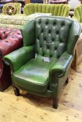 Pair Georgian style green leather deep buttoned wing back armchairs
