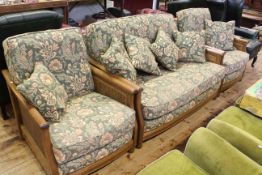 Ercol Bergere panelled three piece lounge suite in green floral tapestry fabric