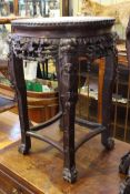 Oriental carved hardwood and marble inset circular shaped top jardiniere stand, 61.