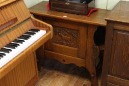Carved oak Continental side cabinet with carved stag panel door and side compartments,