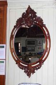 Carved mahogany oval framed wall mirror,