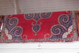 Eastern design carpet with a red and blue ground 3.25 by 2.