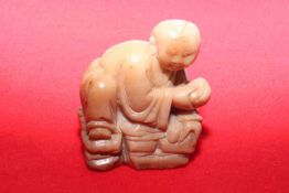 Chinese carving of a crouching Buddha