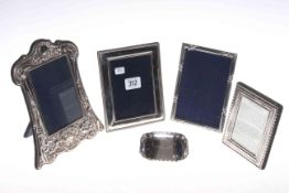 Four silver photograph frames and a silver dish