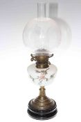 Brass and glass based oil lamp with floral painted opaque glass reservoir and etched shade