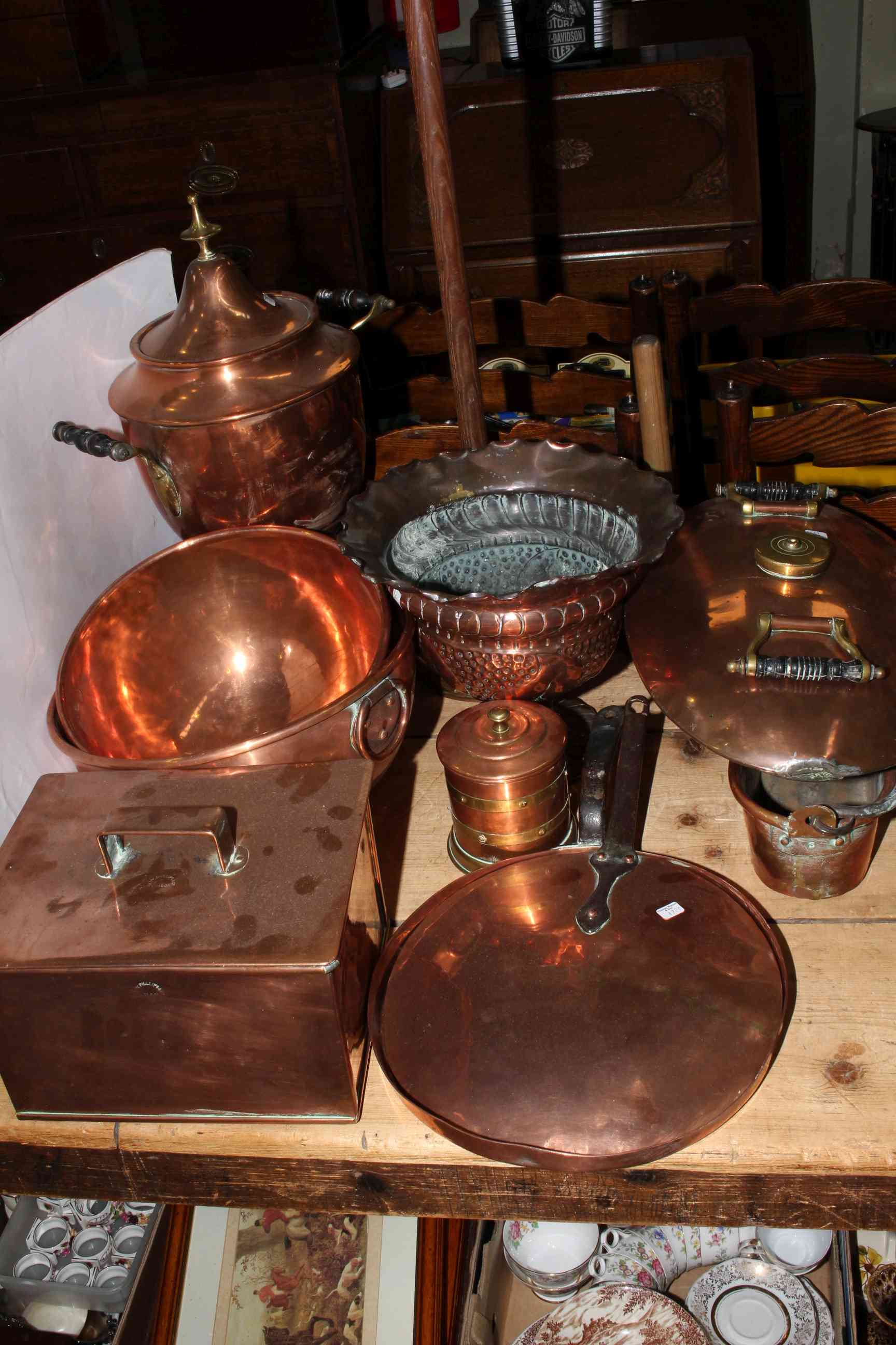 Copper wares including tea urn, hot water bottle, pan lids, box, bowls,