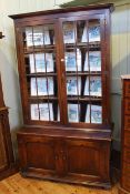 Period style oak four door cabinet bookcase having two glazed panel doors above arched fielded