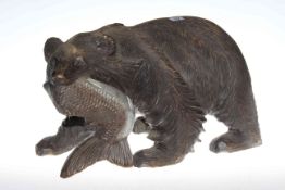 Carved wood model of a grizzly bear carrying a fish