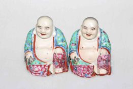 Two Chinese Famille Rose porcelain models of Buddha's, each with impressed marks,
