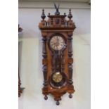 Victorian walnut cased Vienna wall clock with hourglass panels