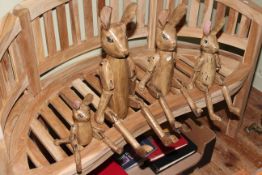 Set of four graduated wooden jointed hares