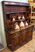 Period style oak dresser, the shelf back above three drawers with three fielded panel doors below,