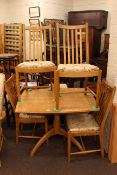 Ercol light elm pedestal dining table and four chairs