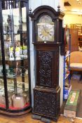 Carved oak eight day longcase clock having moon phase arched dial signed Adam Travers,