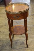Circular French two tier occasional table having pierced brass gallery and frieze drawer, 68.