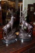 Pair of impressive bronze stags on marble plinths, signed J.