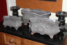 Three cast iron planters and pair of urns