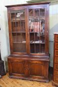 Period style oak four door cabinet bookcase having two glazed panel doors above two arched field