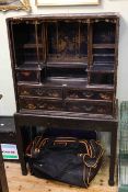 Antique Chinese lacquered cabinet with a series of drawers and compartments on a later stand