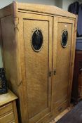 Birds eye maple two door wardrobe with oval gilt metal and glass panels