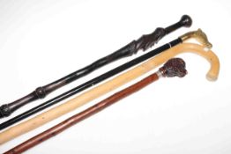 Four walking sticks including dogs lead cane