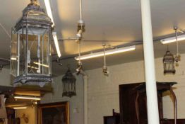 Three ornate metal and glazed graduated hall lanterns