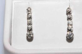Pair of 14 carat white gold five stone diamond drop earrings