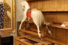 Vintage wooden rocking horse on pine safety stand