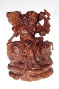 Chinese wood carving of a man astride a creature