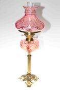 Victorian brass column oil lamp with ruby glass reservoir and shade
