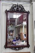 Mahogany framed rectangular bevelled wall mirror with scrolling swan neck and urn pediment,