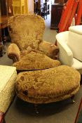 Turned leg armchair and footstool in classical foliate patterned fabric