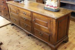 Antique oak dresser having drawers flanked by cupboards and drawers,