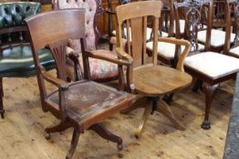 Two early 20th century swivel office desk armchairs