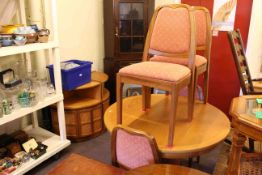 Circular teak extending dining table and four chairs,