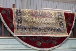 Oval Wilton red ground carpet, 3.66m x 2.75m and Shiraz carpet,. 2.40m x 1.