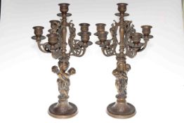 Pair of ornate gilt metal five branch candelabra decorated with cherubs