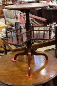 Late Victorian mahogany circular tripod occasional table with revolving galleried undershelf