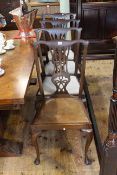 Set of four Queen Anne style oak dining chairs with pierced splat backs