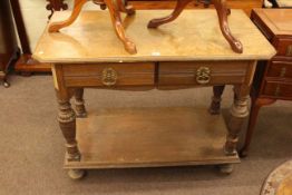 Oak two drawer serving table raised on turned legs with undershelf